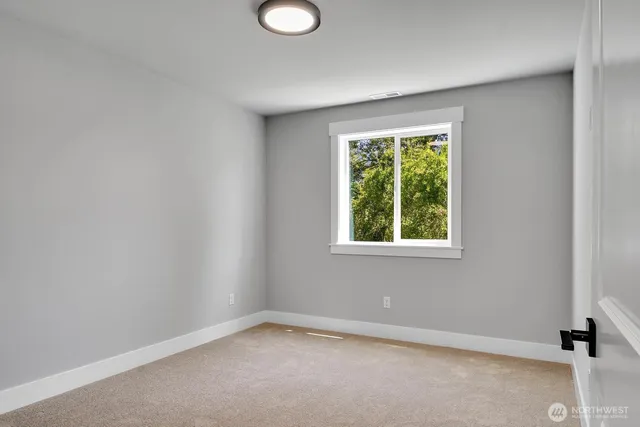 a bathroom with a granite countertop sink a toilet and a mirror