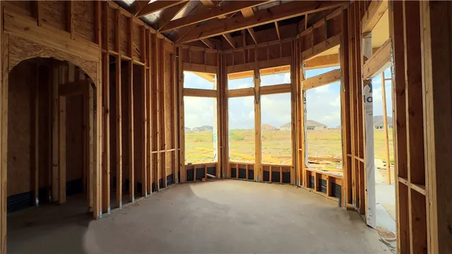 a view of a room with large windows and a table