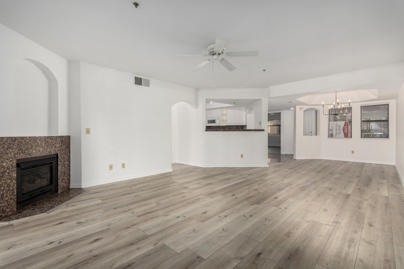5104 North 32nd Street, Unit 225 Phoenix, AZ 85018 - Photo 25 of 31 a view of empty room with wooden floor and fireplace
