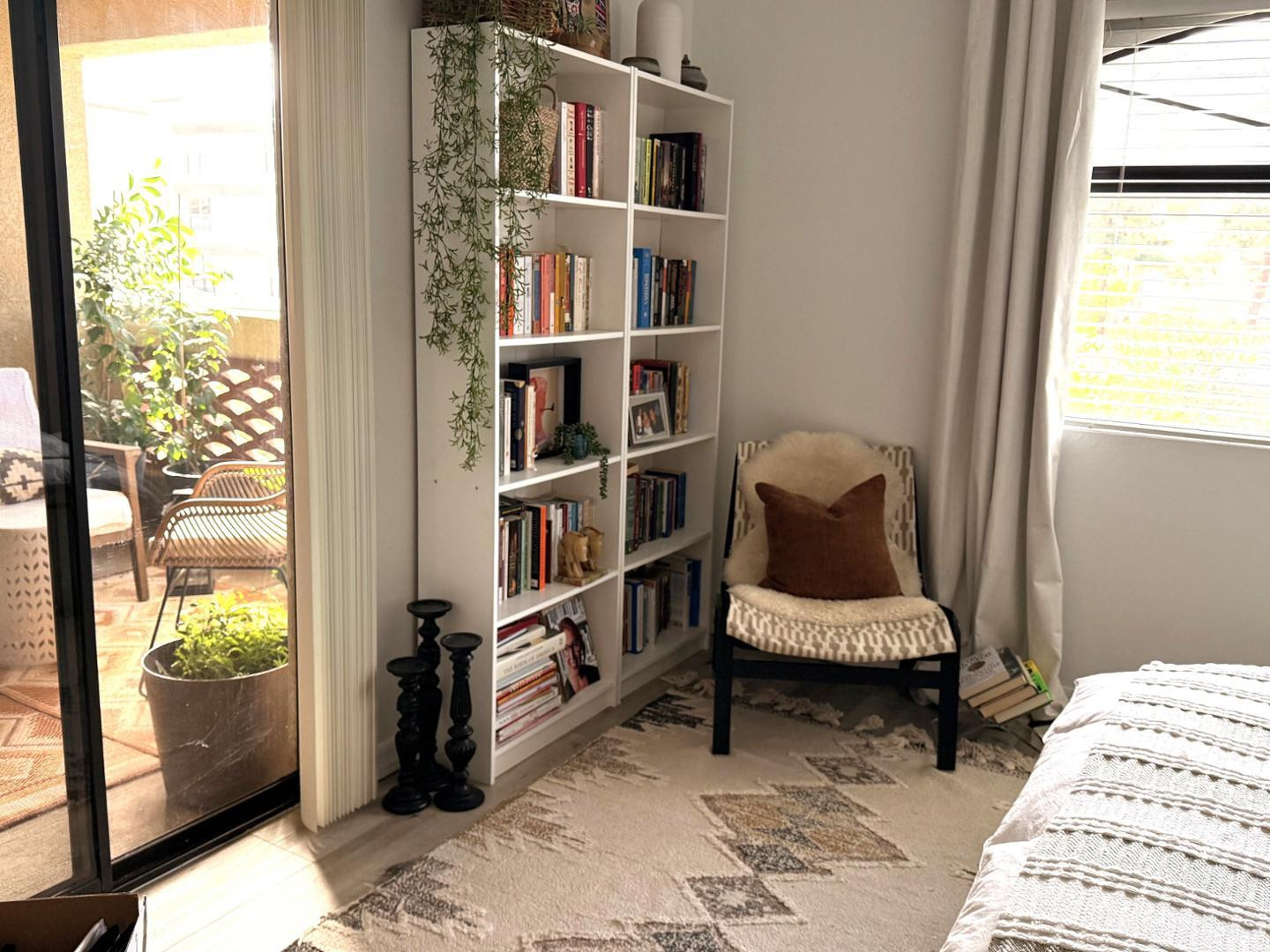 5104 North 32nd Street, Unit 225 Phoenix, AZ 85018 - Photo 26 of 31 a living room with furniture and a book shelf