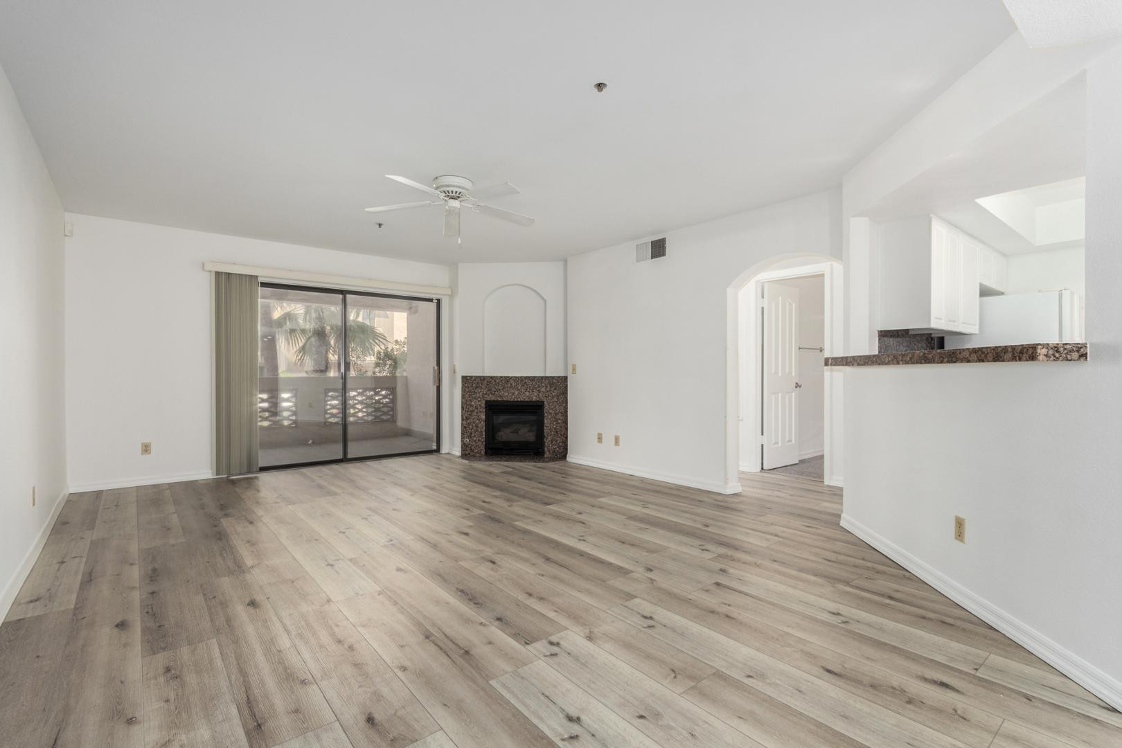 5104 North 32nd Street, Unit 225 Phoenix, AZ 85018 - Photo 3 of 31 a view of empty room with wooden floor and fireplace