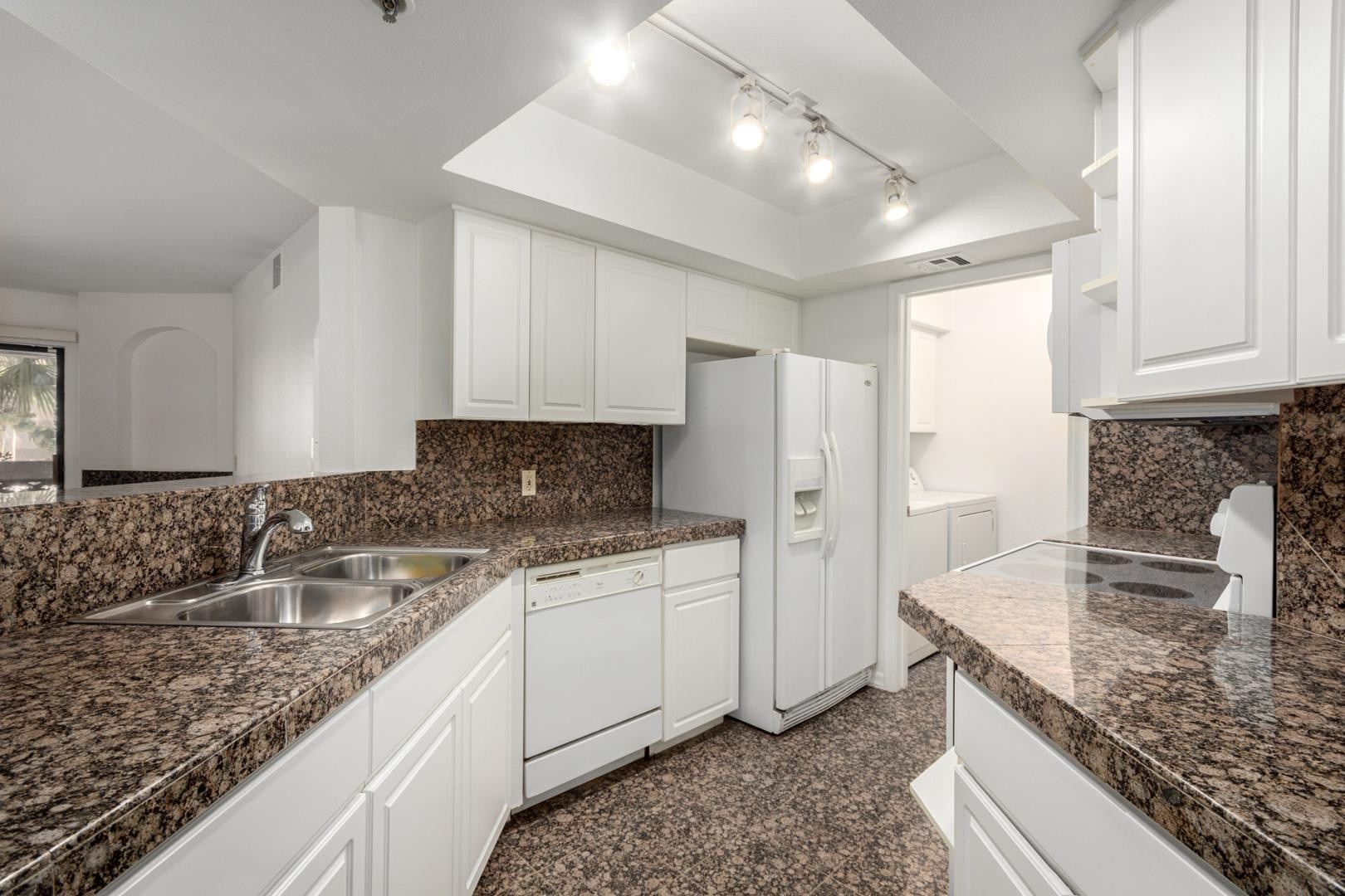 5104 North 32nd Street, Unit 225 Phoenix, AZ 85018 - Photo 4 of 31 a kitchen with a sink stove and refrigerator