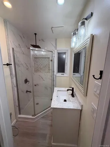 a bathroom with a tub sink and mirror