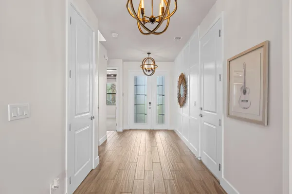 a view of a hallway with wooden floor