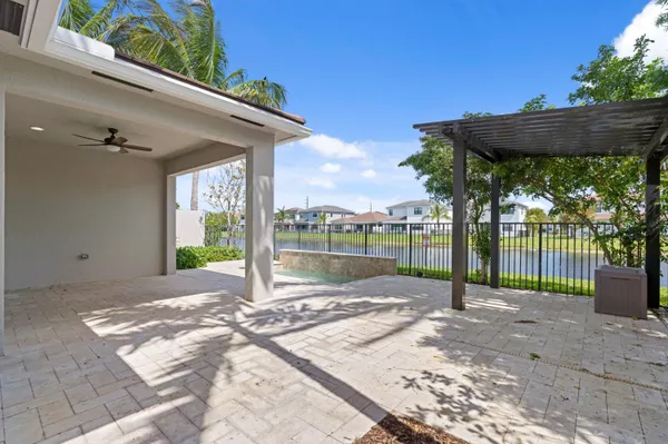 a view of a backyard with a table and chair under an umbrella