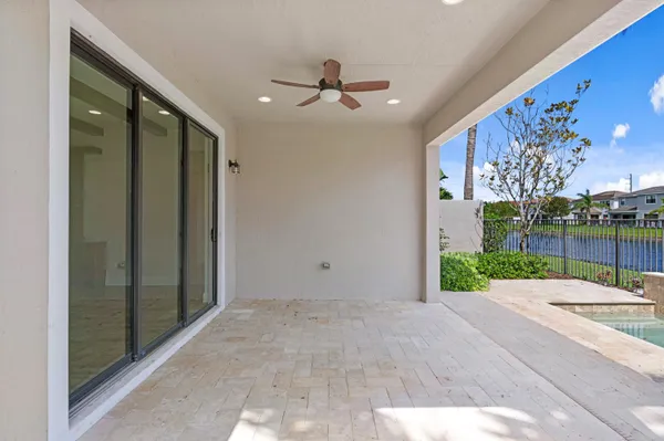 a view of a porch with a table and chairs