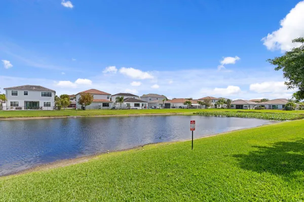 a view of a lake with houses in the back
