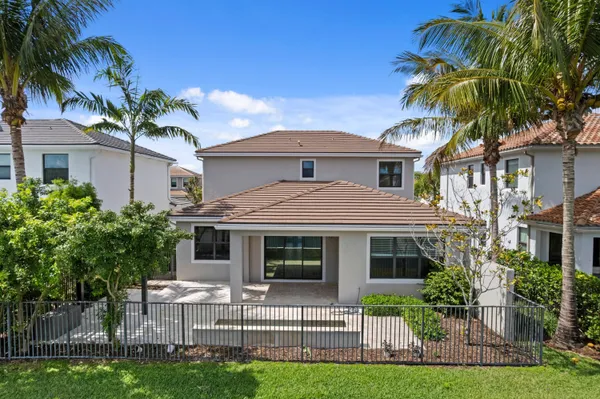 a front view of a house with a garden and plants