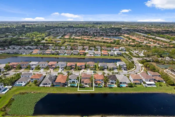 an aerial view of house with yard swimming pool and outdoor seating