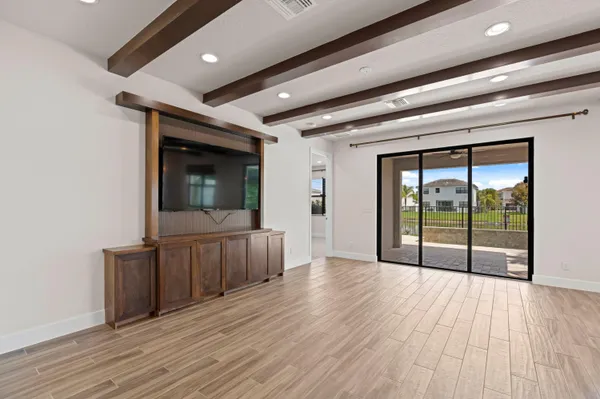 a view of room with wooden floor and furniture