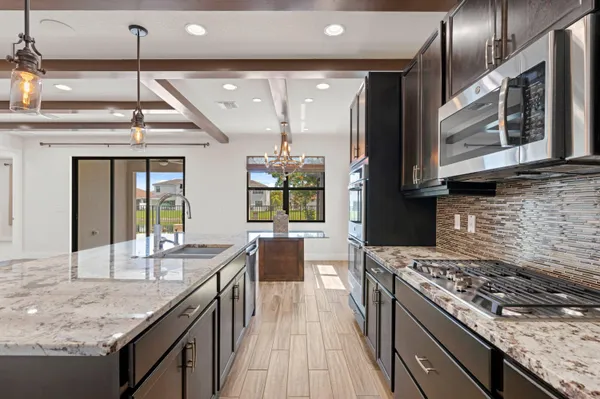 a kitchen with stainless steel appliances granite countertop a stove and a sink