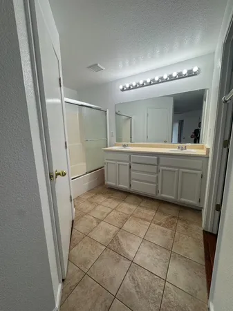 a bathroom with a mirror and a sink