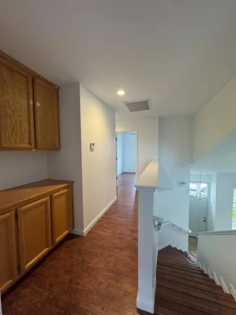 a view of kitchen and hall with wooden floor