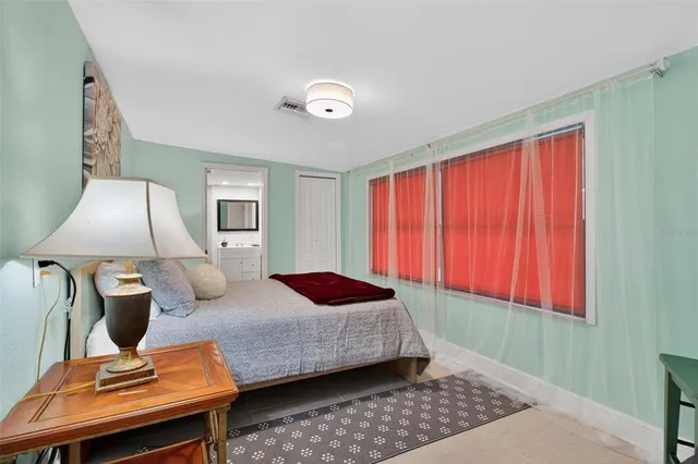 a bedroom with furniture and a window