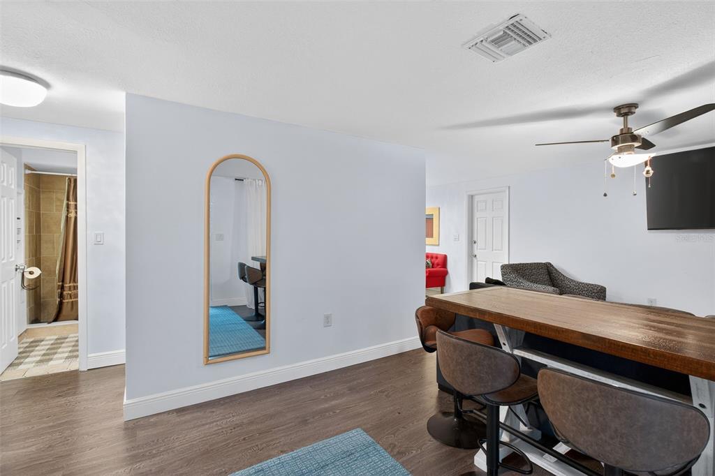 3214 Huntington Road Holiday, FL 34691 - Photo 4 of 26 a view of a workspace with furniture and wooden floor