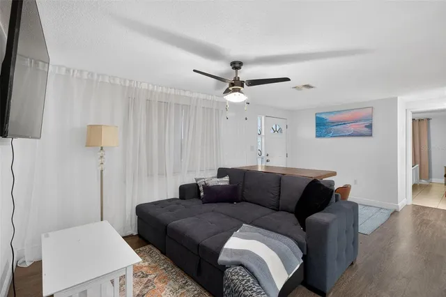 a bedroom with a bed couch and a window