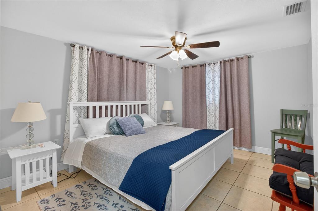 3214 Huntington Road Holiday, FL 34691 - Photo 7 of 26 a bed room with a bed and a chandelier