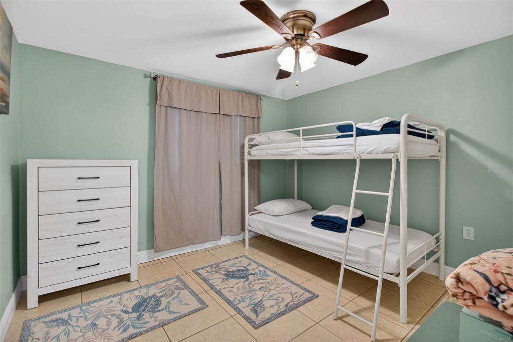 3214 Huntington Road Holiday, FL 34691 - Photo 8 of 26 a bedroom with a bed and a chandelier