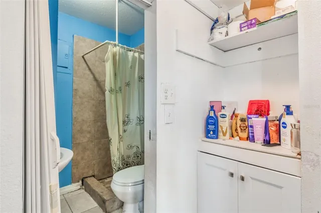 a bathroom with a shower and a sink