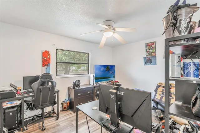 a view of a workspace with furniture and a window