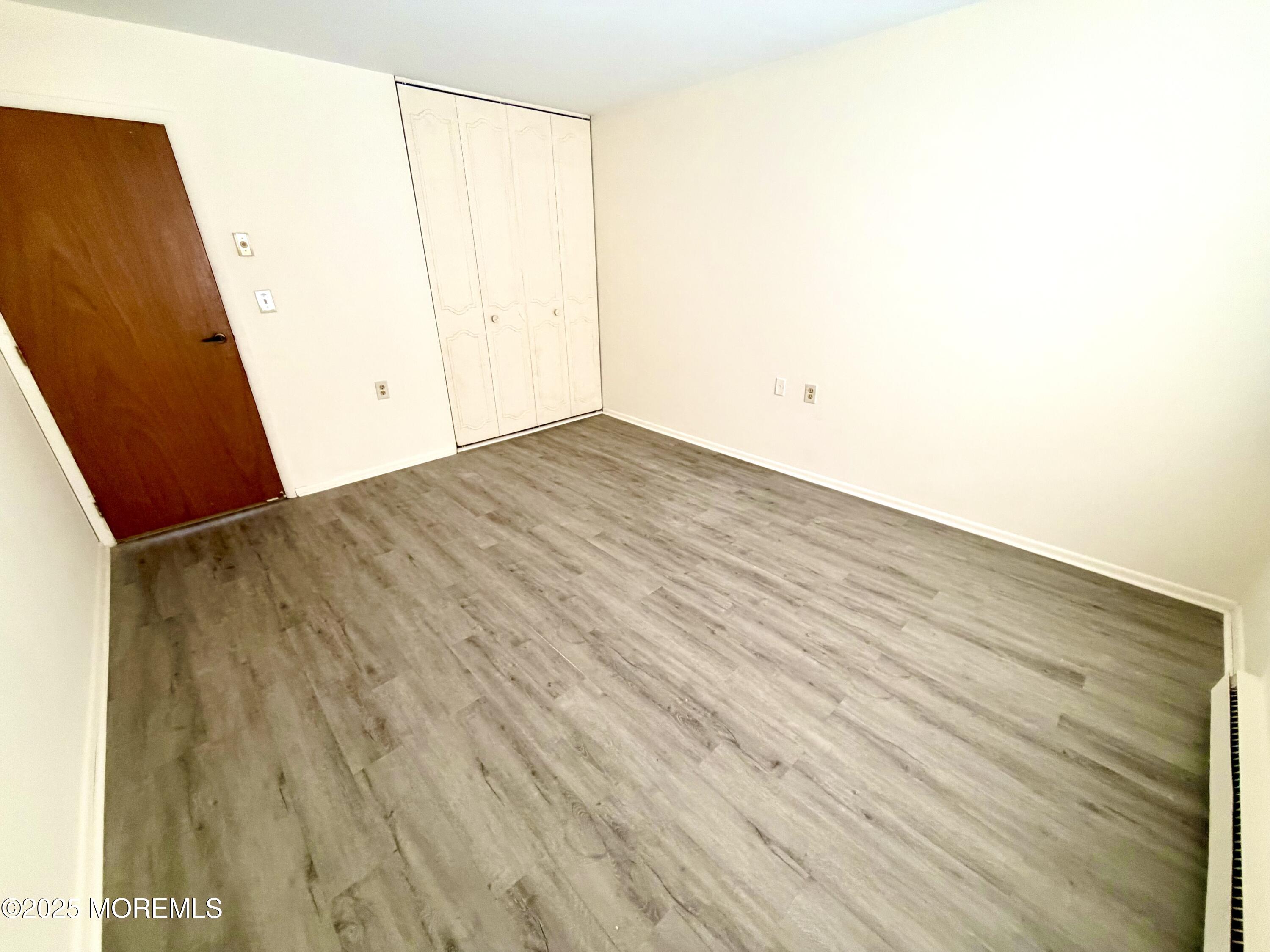 842 B Inverness Court Lakewood, NJ 08701 - Photo 11 of 18 a view of a room with wooden floor