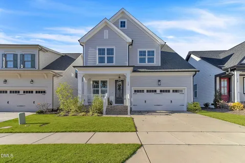 a front view of a house with a garden and yard