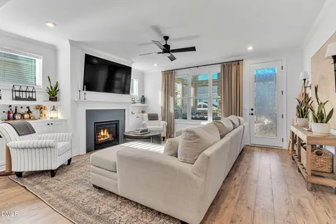 a living room with furniture fireplace and flat screen tv