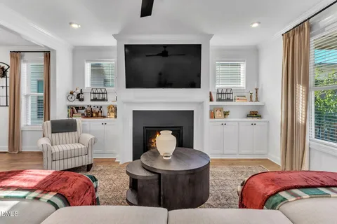 a living room with furniture fireplace and flat screen tv