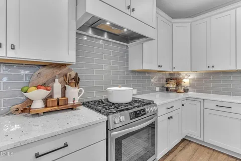 a kitchen with a stove and cabinets