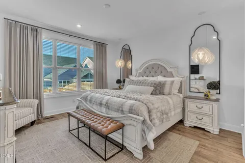 a bedroom with bed and a large window