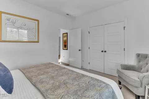 a bedroom with a bed and a couch