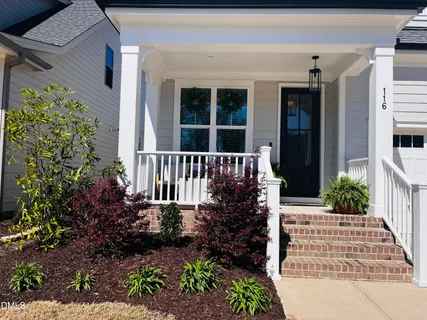 a front view of a house with a garden