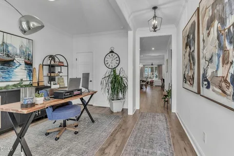 a view of a room with furniture and wooden floor