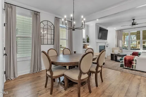 a view of a a dining room with furniture window and wooden floor