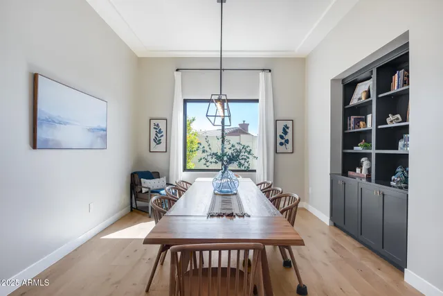 a kitchen with stainless steel appliances kitchen island granite countertop a table and chairs in it