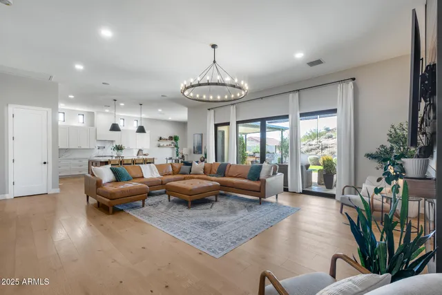 a kitchen with stainless steel appliances granite countertop a sink a stove and a wooden floors