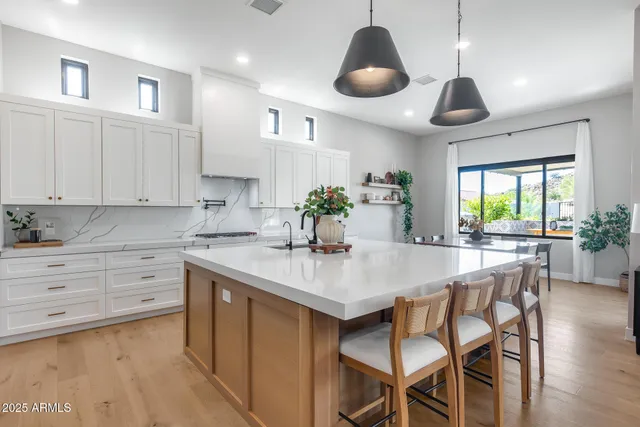 a kitchen with a stove a sink and a refrigerator