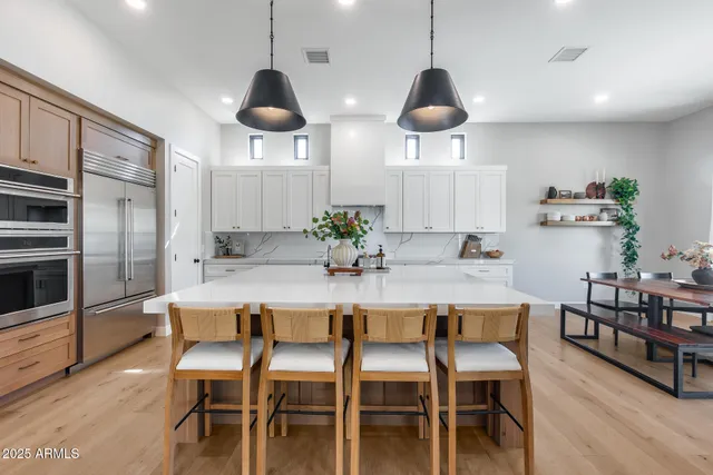 a dining room with furniture window and wooden floor