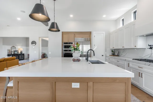 a living room with fireplace furniture and a chandelier