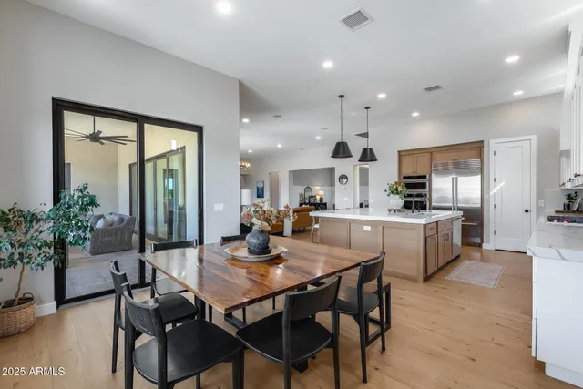 a spacious bathroom with a double vanity sink a mirror and a bathtub