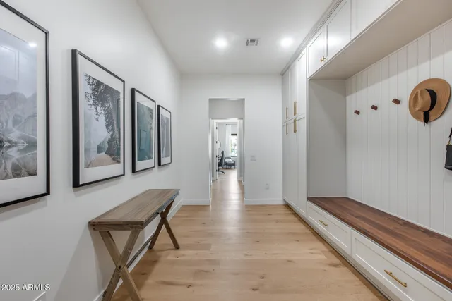 a view of a patio with couches chairs potted plants and a big house