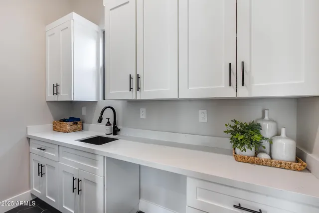 a view of a patio with couches table and chairs under an umbrella