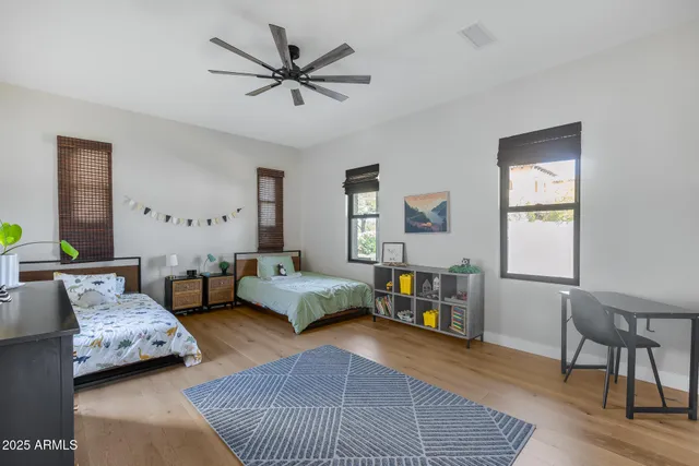 a view of a patio with table and chairs potted plants with floor to ceiling window