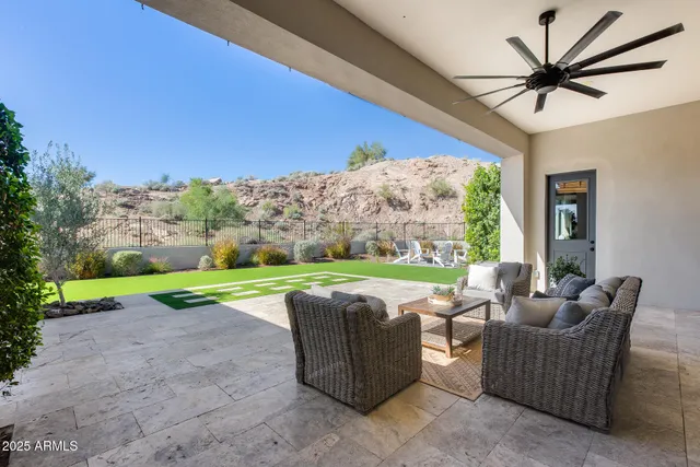 an aerial view of a house with a yard garage and lake view