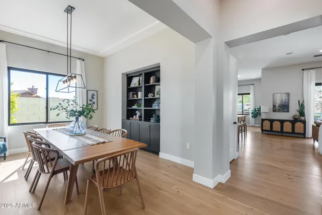 a living room with furniture fireplace and a large window