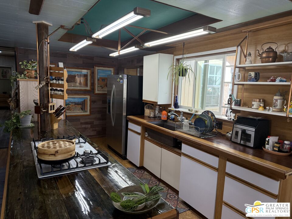 18131 Langlois Road, Unit H1 Desert Hot Springs, CA 92241 - Photo 12 of 44 a kitchen with sink stove and cabinets