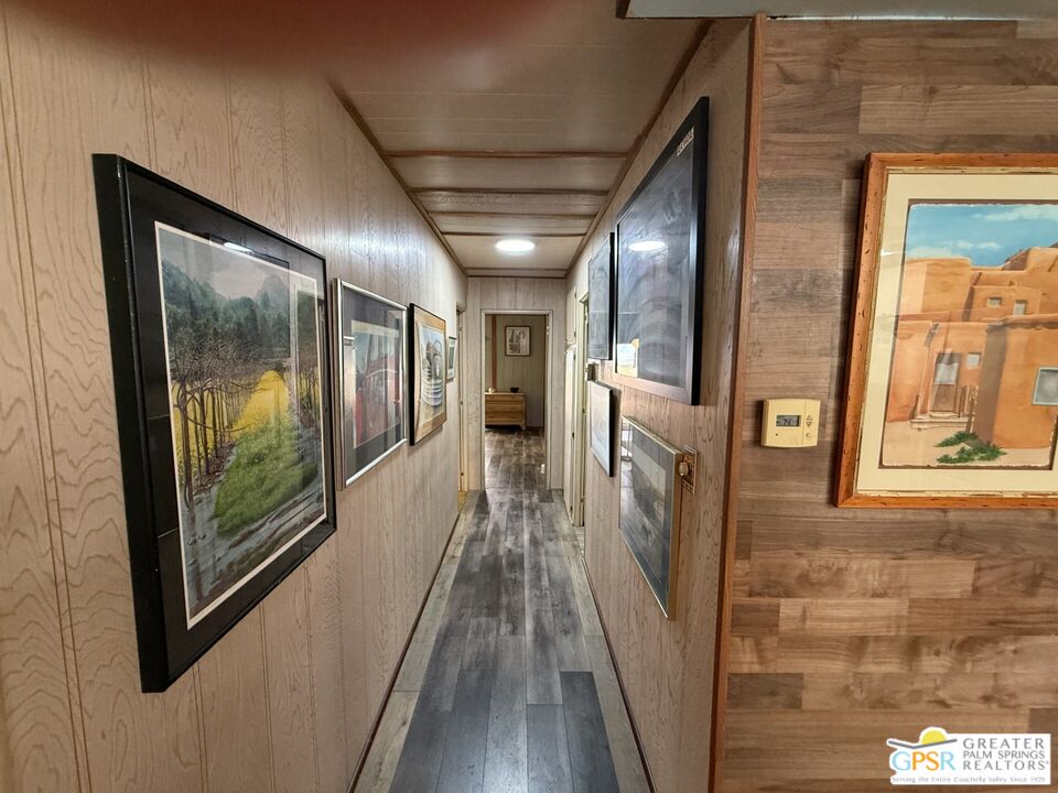18131 Langlois Road, Unit H1 Desert Hot Springs, CA 92241 - Photo 14 of 44 a view of a hallway with wooden floor and staircase