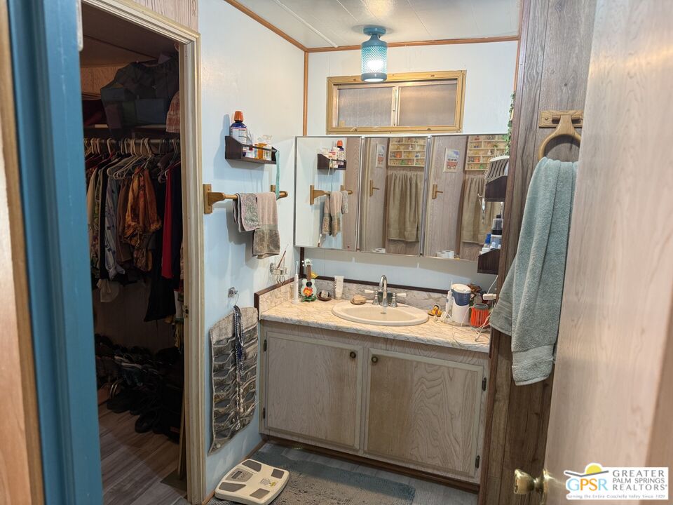 18131 Langlois Road, Unit H1 Desert Hot Springs, CA 92241 - Photo 19 of 44 a bathroom with a mirror sink and shower