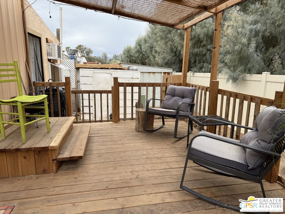 18131 Langlois Road, Unit H1 Desert Hot Springs, CA 92241 - Photo 21 of 44 a balcony with wooden floor outdoor seating and stairs