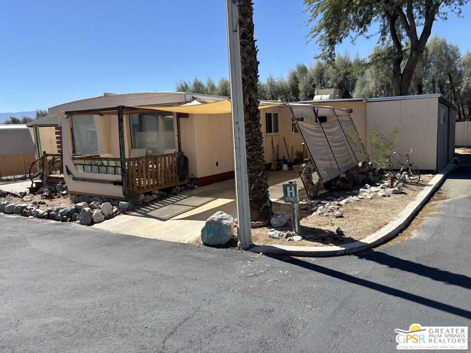 18131 Langlois Road, Unit H1 Desert Hot Springs, CA 92241 - Photo 34 of 44 a view of a patio with wooden fence